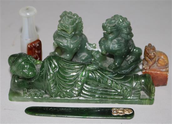 A Chinese spinach jade reclining Buddha and other stone carvings